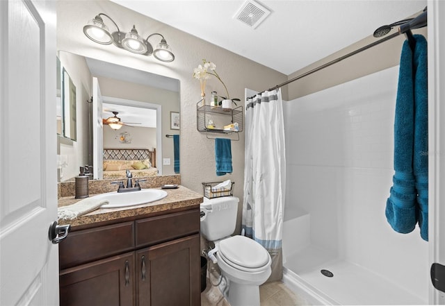 bathroom with curtained shower, tile patterned flooring, vanity, ceiling fan, and toilet