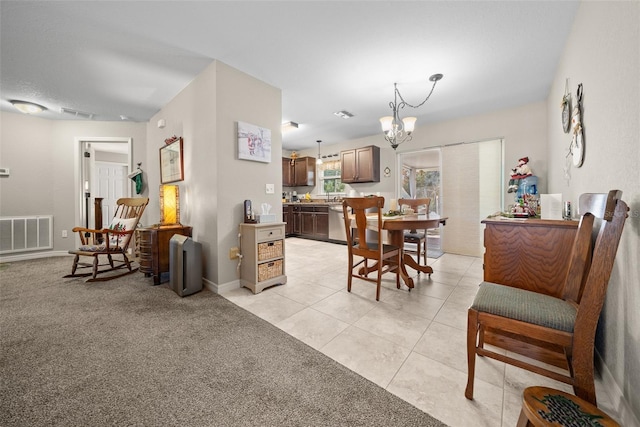 dining area featuring light tile patterned flooring and a notable chandelier