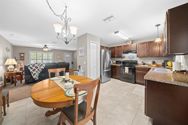 tiled dining area featuring sink and ceiling fan with notable chandelier