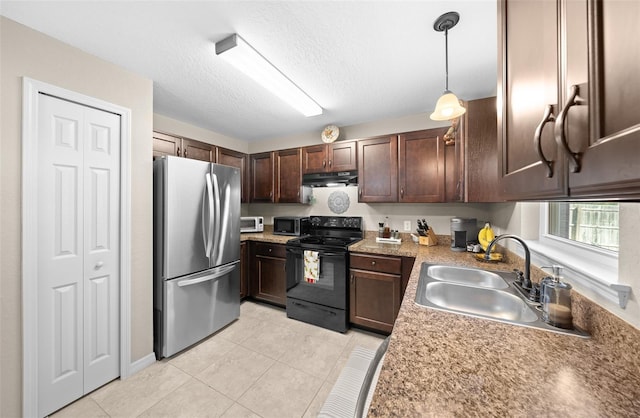 kitchen with sink, dark brown cabinets, light tile patterned floors, pendant lighting, and stainless steel appliances