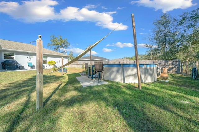 view of yard with a fenced in pool