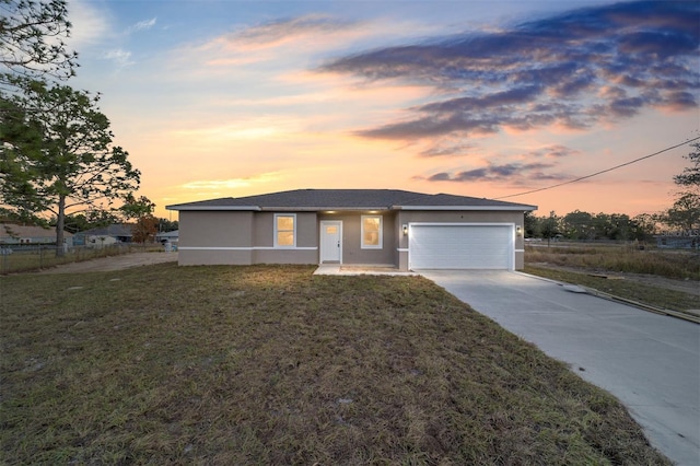 view of front of home featuring a garage and a yard