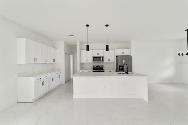 kitchen with a large island, hanging light fixtures, white cabinets, and stainless steel appliances