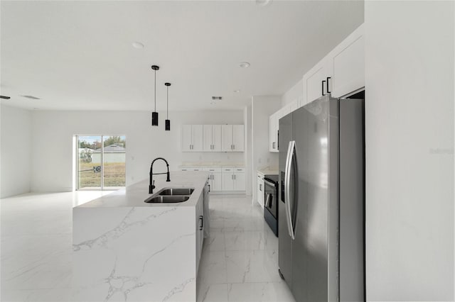 kitchen with stainless steel fridge with ice dispenser, sink, white cabinets, and a center island with sink