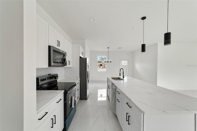 kitchen featuring sink, white cabinets, decorative light fixtures, and appliances with stainless steel finishes