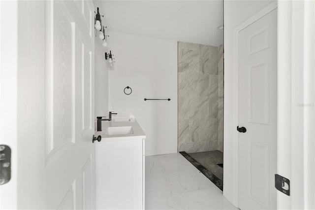 bathroom featuring vanity and tiled shower