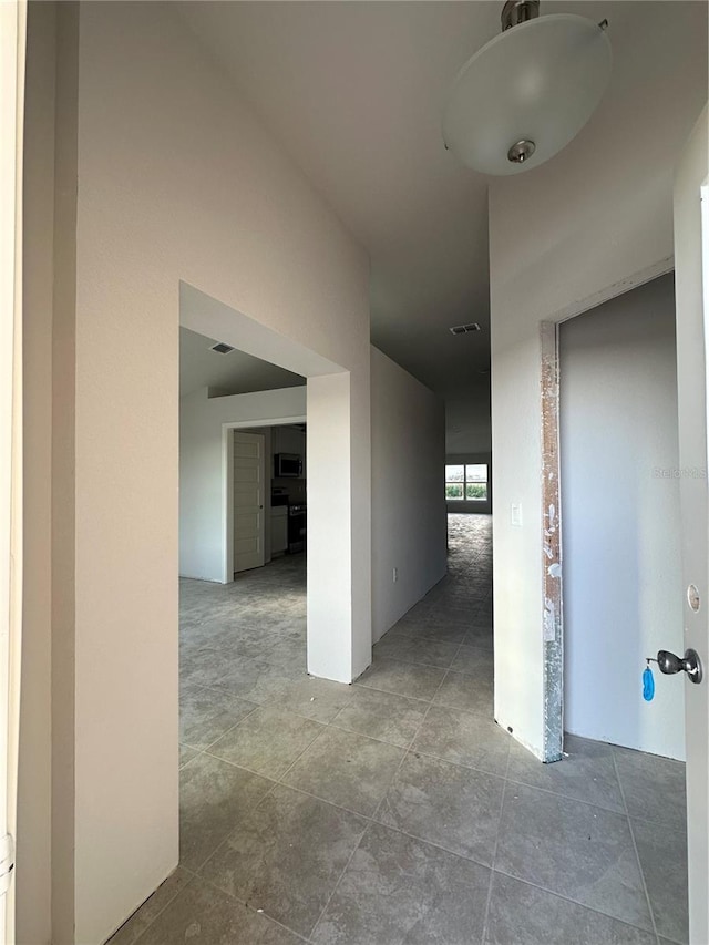 hall with tile patterned flooring