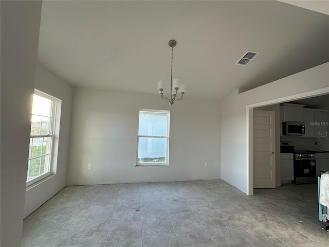 unfurnished dining area featuring vaulted ceiling, a wealth of natural light, and a notable chandelier