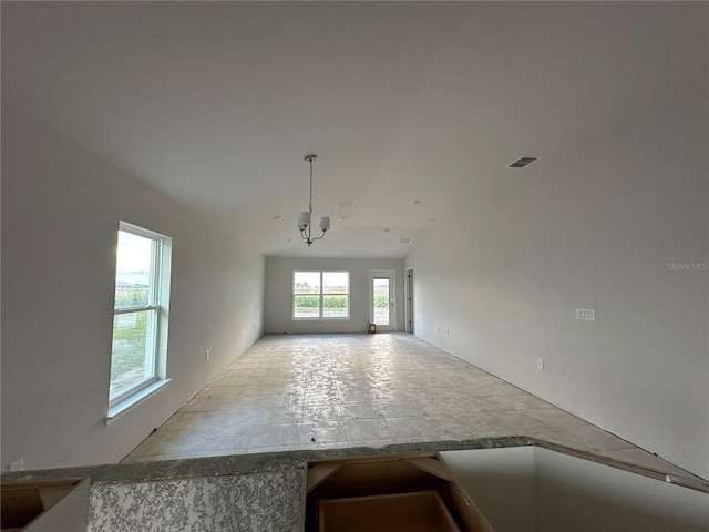 spare room with a notable chandelier