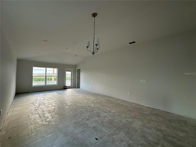 unfurnished room with lofted ceiling and a chandelier