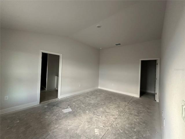 empty room featuring vaulted ceiling