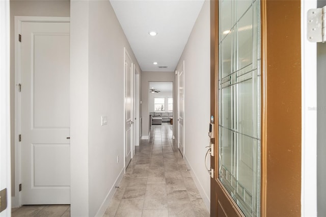 hall with light tile patterned floors