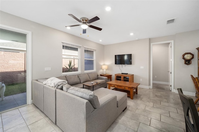 living room with light tile patterned floors and ceiling fan