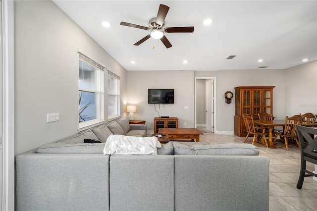 tiled living room featuring ceiling fan