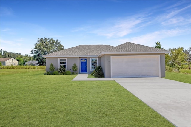 ranch-style house featuring a garage and a front lawn