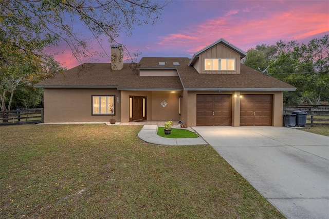 view of front of house featuring a garage and a yard