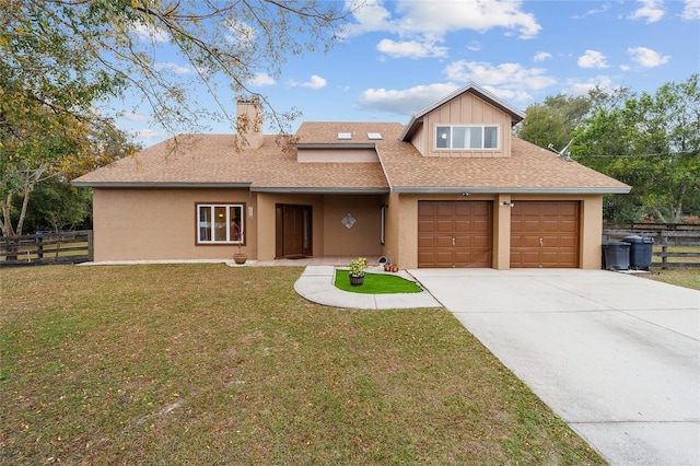 view of front of house featuring a front yard and a garage