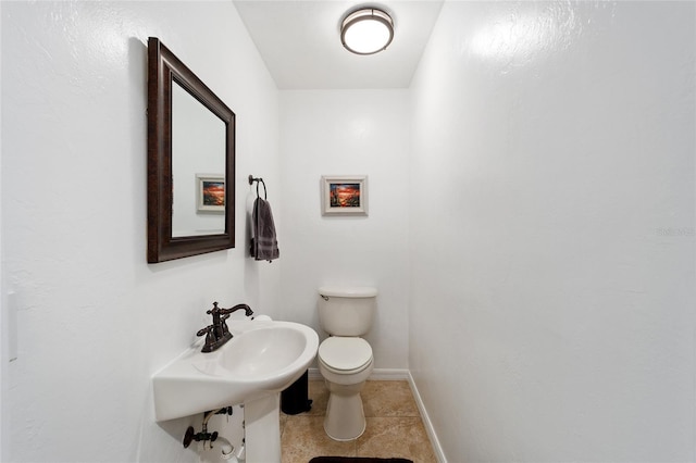 bathroom featuring tile patterned floors, toilet, and sink