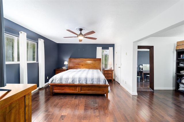 bedroom with ceiling fan, dark hardwood / wood-style floors, and multiple windows