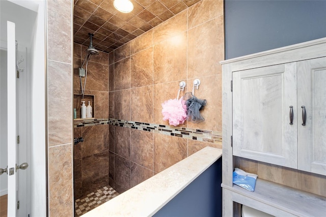 bathroom with a tile shower