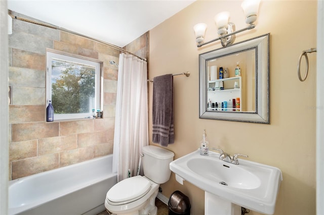 full bathroom with toilet, sink, and shower / tub combo with curtain