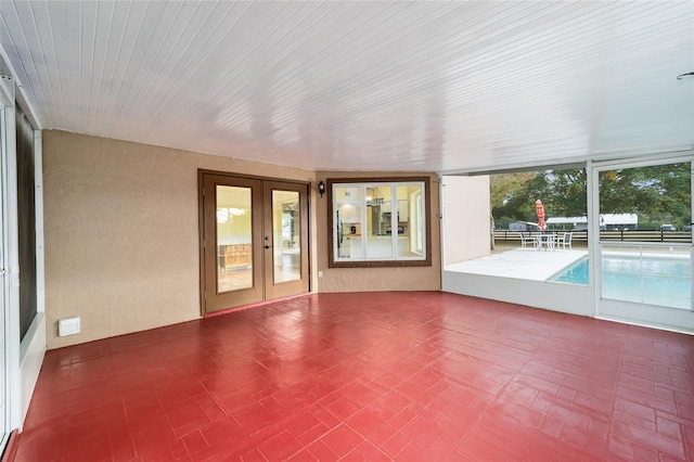 unfurnished sunroom with french doors