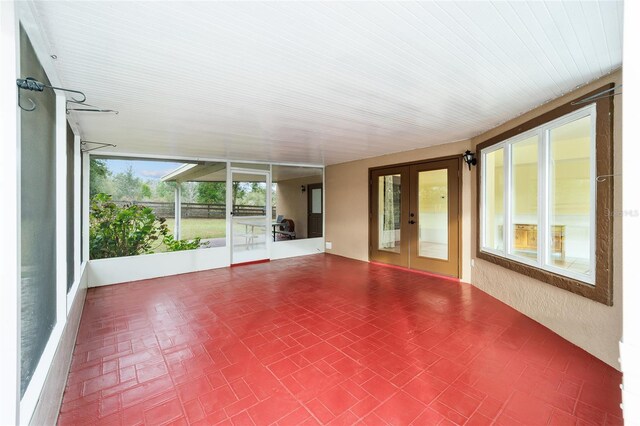 unfurnished sunroom with french doors