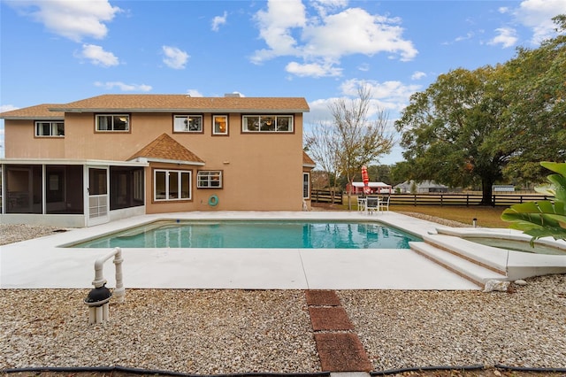 view of pool with a patio area and a sunroom