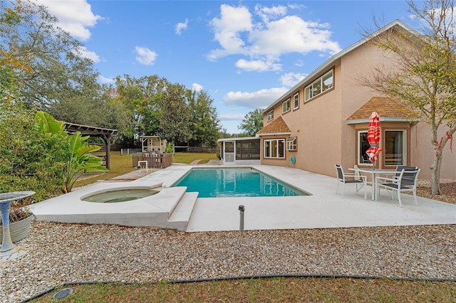 view of pool featuring a sunroom, an in ground hot tub, and a patio