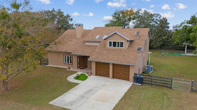 view of front of home featuring a front lawn, central AC unit, and a garage