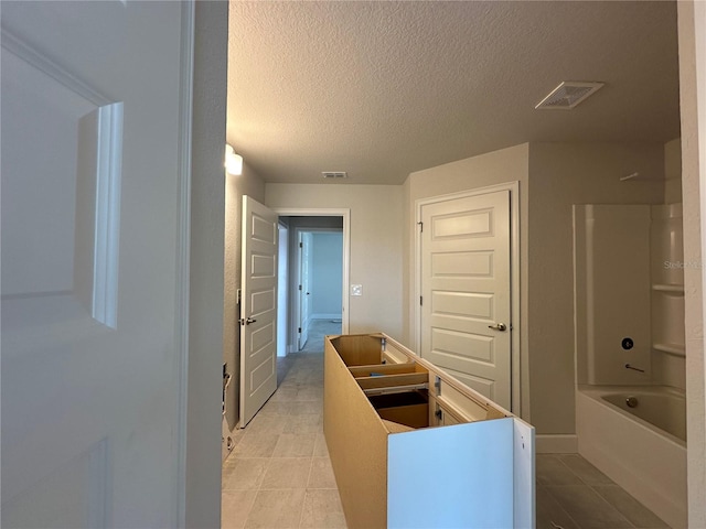 bathroom featuring a textured ceiling