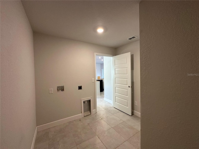 washroom featuring hookup for a washing machine, light tile patterned floors, and electric dryer hookup