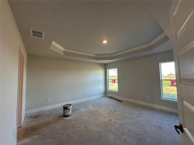 empty room with a tray ceiling and crown molding