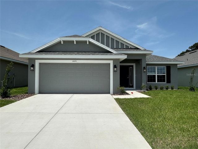 4445 SW 90th Pl, Ocala, FL 34476 - view of front of home featuring a garage, stucco siding, concrete driveway, and a front lawn