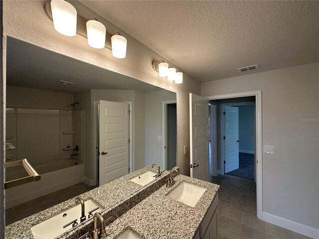 4445 SW 90th Pl, Ocala, FL 34476 - bathroom featuring a textured ceiling,  shower combination, double vanity, baseboards, and tile patterned flooring