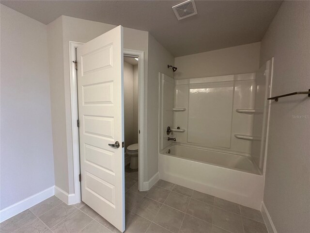 4445 SW 90th Pl, Ocala, FL 34476 - bathroom with baseboards, toilet, tile patterned floors, and shower / tub combination