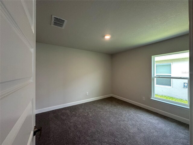 4445 SW 90th Pl, Ocala, FL 34476 - spare room with dark colored carpet, baseboards, and recessed lighting