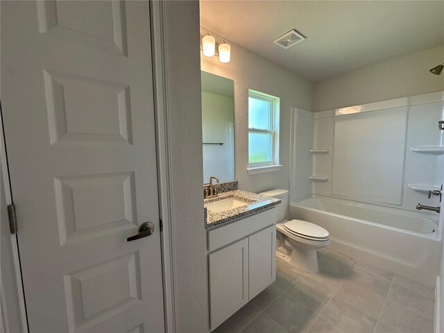 4445 SW 90th Pl, Ocala, FL 34476 - full bath featuring toilet, vanity, tile patterned flooring,  shower combination, and a textured wall