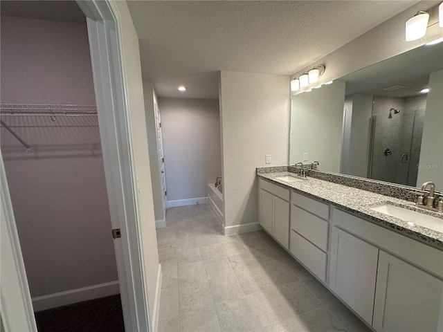 4445 SW 90th Pl, Ocala, FL 34476 - bathroom with a stall shower, a spacious closet, double vanity, a garden tub, and baseboards