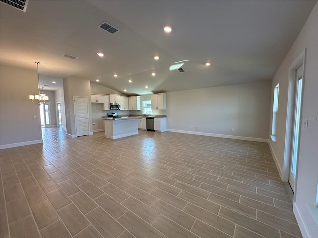 unfurnished living room with a chandelier, vaulted ceiling, and light hardwood / wood-style flooring