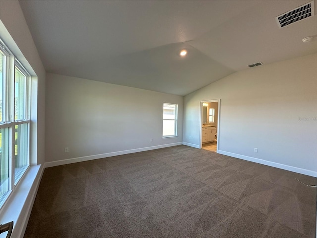 spare room with carpet and lofted ceiling