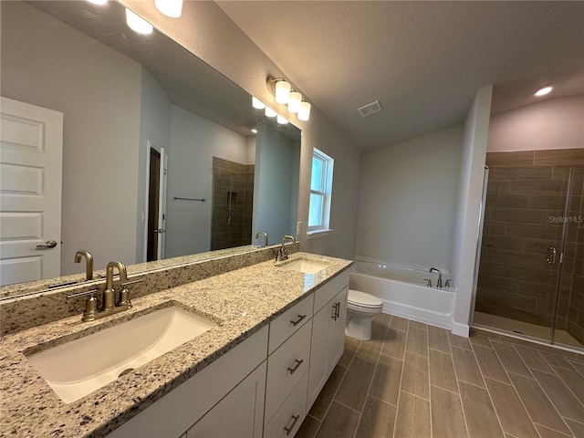 full bathroom with vanity, separate shower and tub, and toilet