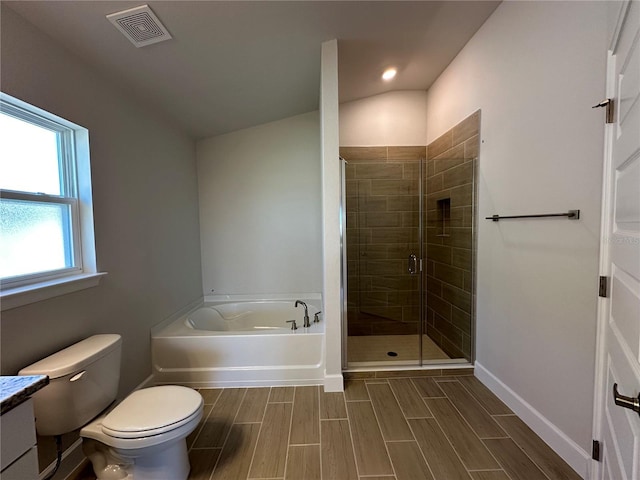 full bathroom featuring independent shower and bath, vanity, toilet, and vaulted ceiling