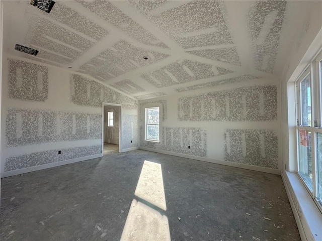 empty room featuring lofted ceiling