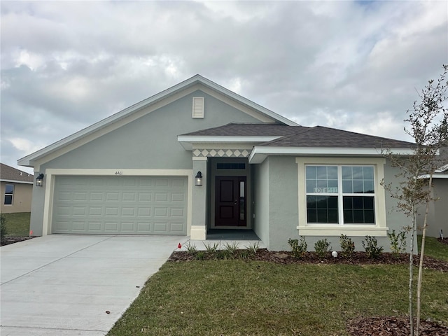 ranch-style home featuring a front yard, driveway, a shingled roof, stucco siding, and a garage