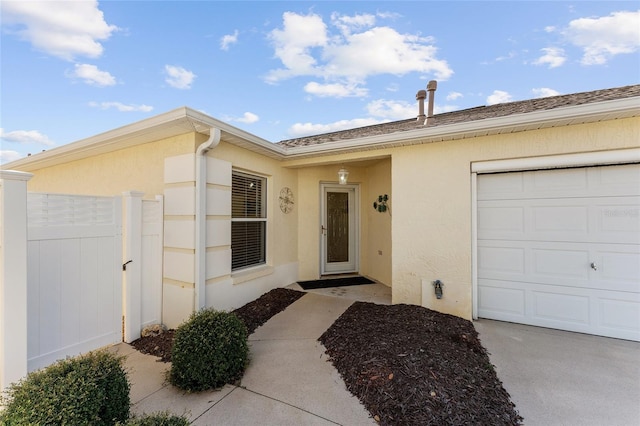 view of exterior entry with a garage