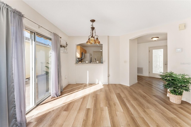 unfurnished dining area featuring light hardwood / wood-style flooring