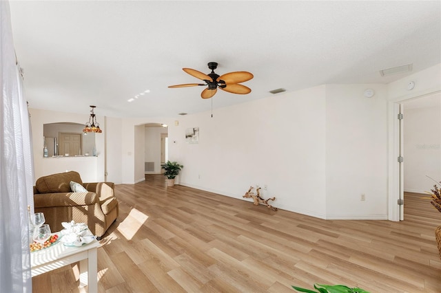 living room with ceiling fan and light hardwood / wood-style flooring