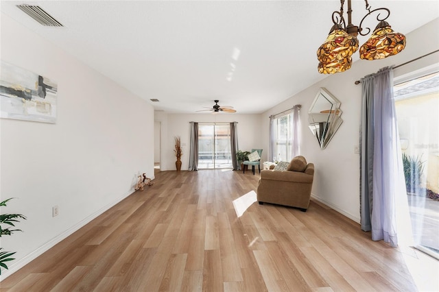 living room with ceiling fan and light wood-type flooring