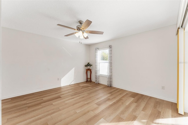 spare room with ceiling fan, light hardwood / wood-style flooring, and a textured ceiling